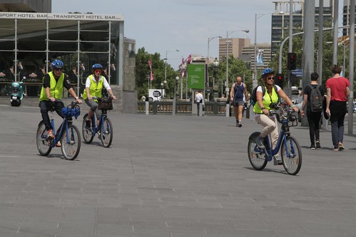 Trio of Melbourne Bike Share users in hi-viz vests