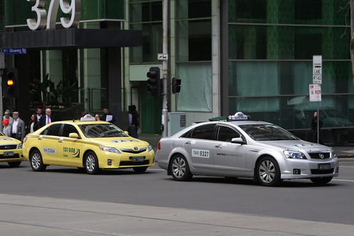 New and old: original yellow taxi beside a new silver one