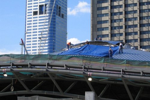 Workers busy at work cladding the roof