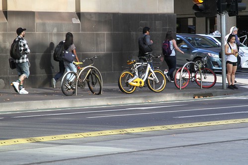 oBikes chained up to a bike rack at William and Little Bourke Street