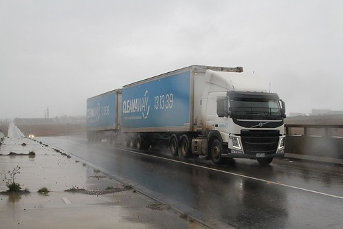 Cleanaway A-double truck heads through the rain, returning to Dandenong South for another load of rubbish from the South East Melbourne Transfer Station