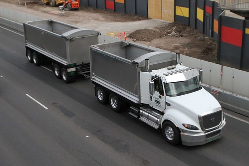 Tip truck and dog trailer on the West Gate Freeway at Brooklyn