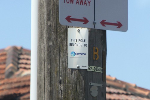 'This pole belongs to Jemena' plaque on a power pole in Powercor territory - Ballarat Road, Braybrook