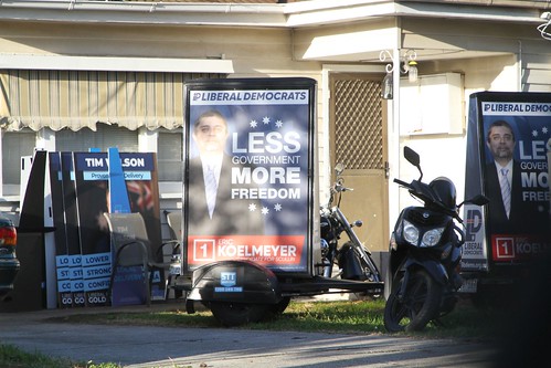 'Eric Kolmeyer, Liberal Democrats for Scullin' advertising signs hooked up behind motor scooters