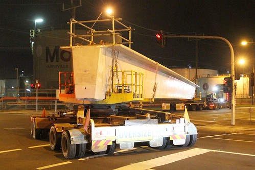 Semi-trailer transporting oversize precast concrete super T-girders around the corner of Francis Street and Hyde Street, Yarraville