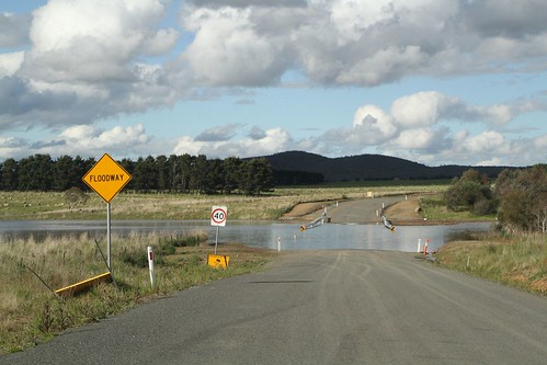 Narambulla Creek has spilled over the floodway on Carrick Road in Carrick