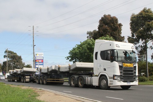 Legend Logistics A-double truck carriers four precast tunnel lining segments along Ballarat Road, Sunshine on the long journey from the Benalla precast yard to the West Gate Tunnel project site at Yarraville