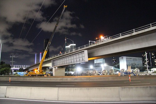 Crane lifts away the billboard on the Ingles Street bridge over the West Gate Freeway at Port Melbourne