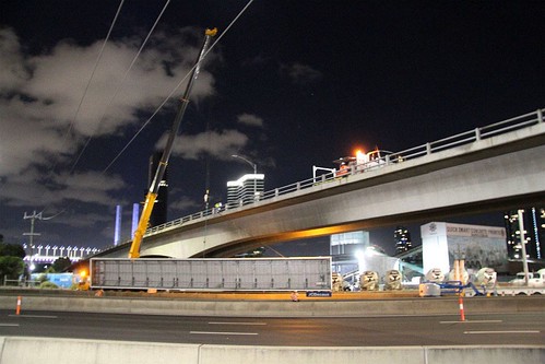 Crane lifts away the billboard on the Ingles Street bridge over the West Gate Freeway at Port Melbourne