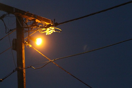 'Watchman' security lighting shines on private property from utility owned power poles