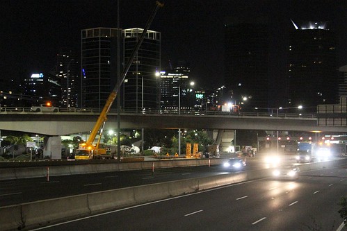 Crane lifts away the billboard on the Ingles Street bridge over the West Gate Freeway at Port Melbourne