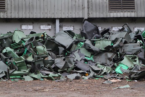 Pile of broken plastic wheelie bins picked out from the incoming organic waste stream