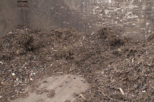 Stockpiles of finished mulch outside the composting shed