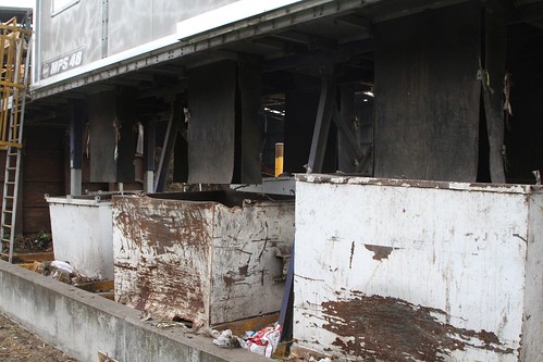 Rubbish skips beneath the sorting shed contain rubbish removed by hand from the incoming organic waste stream