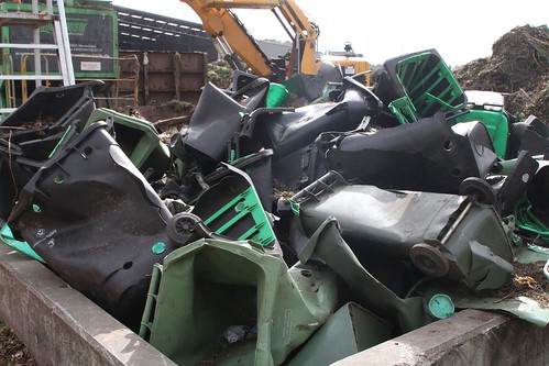 Pile of broken plastic wheelie bins picked out from the incoming organic waste stream