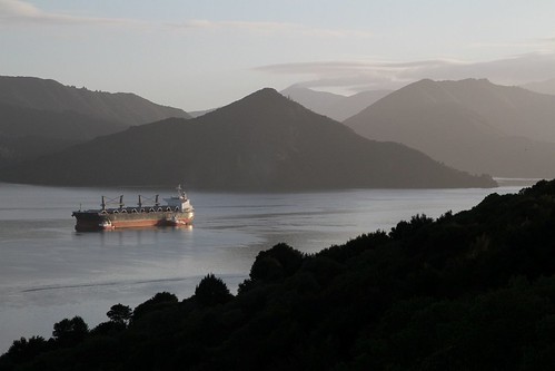 Bulk carrier Elbabe heads along Queen Charlotte Sound bound for Picton with tugs Monowai and Maungatea alongside