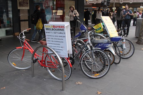 Seven parked bikes, three of them there for advertising purposes.