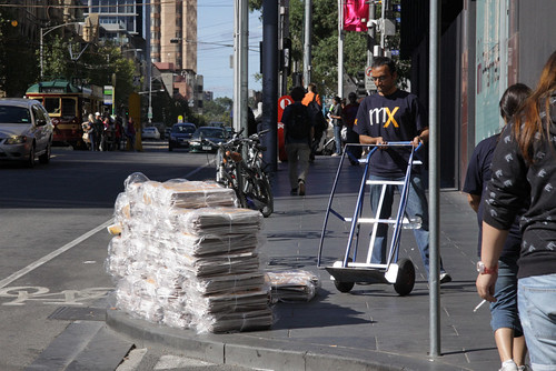 Shifting a stack of mX newspapers into Melbourne Central Station