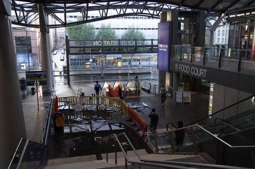 Puddles on the concourse from the storm damage