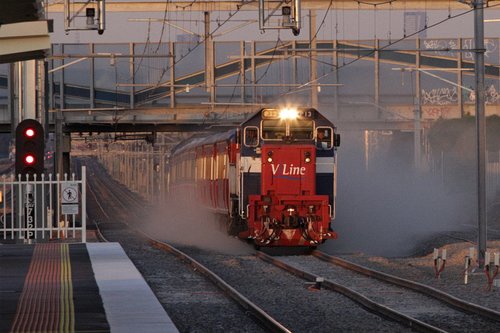 P13 leads a second push-pull football special through Laverton, kicking up the dust on relaid track