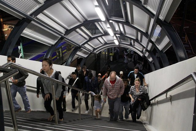 Passengers climb the new stairs from platform 4