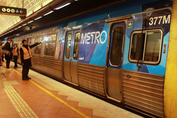 Platform attendant at Flagstaff indicating to the driver the doors are clear with an illuminated paddle