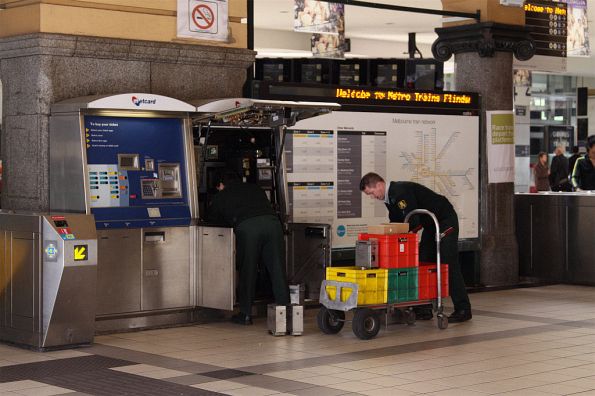 Armaguard staff swapping over the cash vaults from the Metcard machines at Flinders Street Station