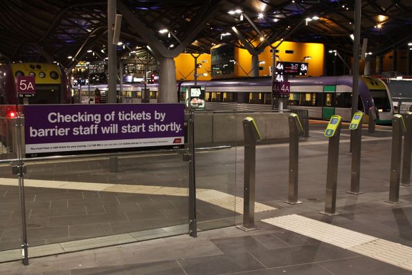 Sign informing passengers that ticket checking will soon start on the country platforms