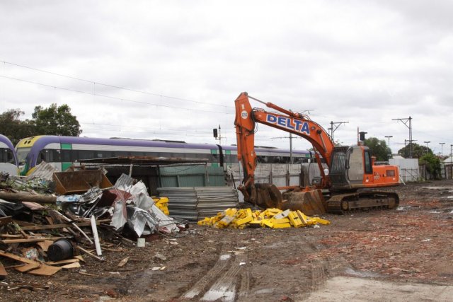 VLocity passes an excavator and a pile of rubble