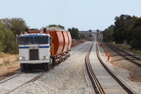 Coleman Rail hi-rail pushing loaded ballast wagons