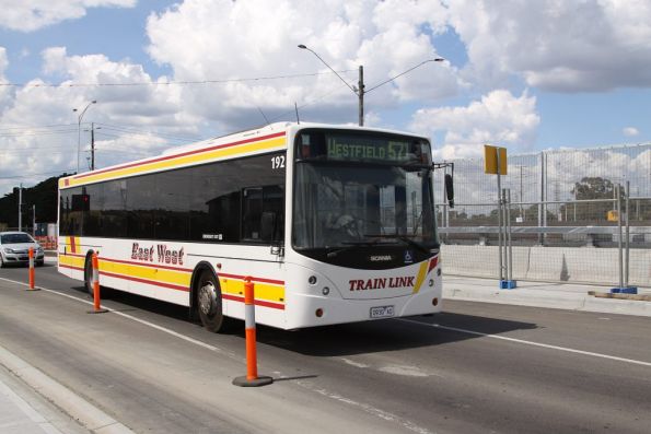 East West #192 rego 0930AO crosses over the new South Morang railway station with a route 571 Trainlink service