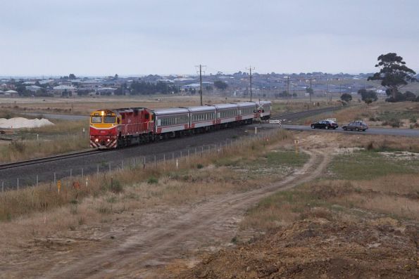 N460 leads the down Warrnambool out of Geelong at the temporary Anglesea Road level crossing