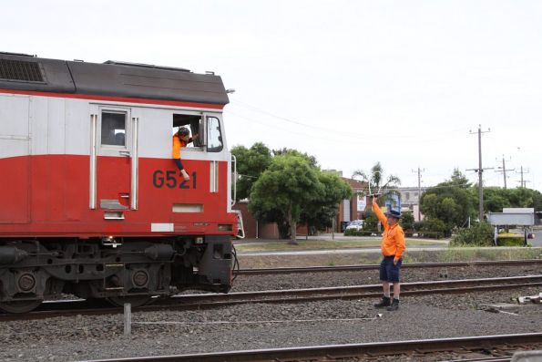 Signaller holds the Train Staff for the Grain Loop, the second person ready to grab hold of it