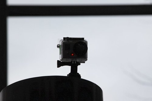 GoPro camera stuck atop a post