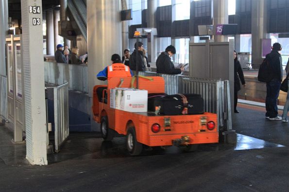 Wilson Security staff drives an electric buggy loaded with parcels and baggage into the subway from platform 14