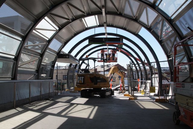 Demolishing the northern end of the footbridge, it was too short to span the future suburban tracks