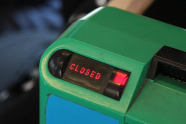 Metcard validator onboard a tram, displaying a 'CLOSED' message and a red light