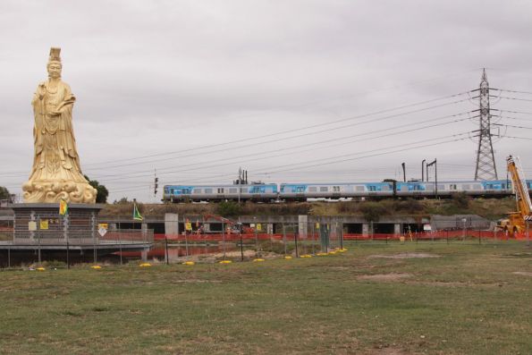 Comeng train passes the Heavenly Queen Temple on the banks of the Maribyrnong at Footscray