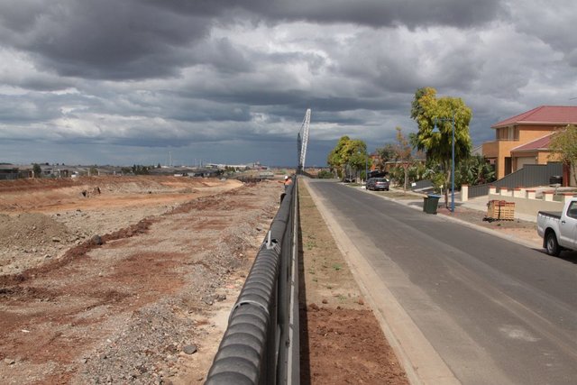 Permanent concrete barriers in place along the RRL cutting at Manor Lakes