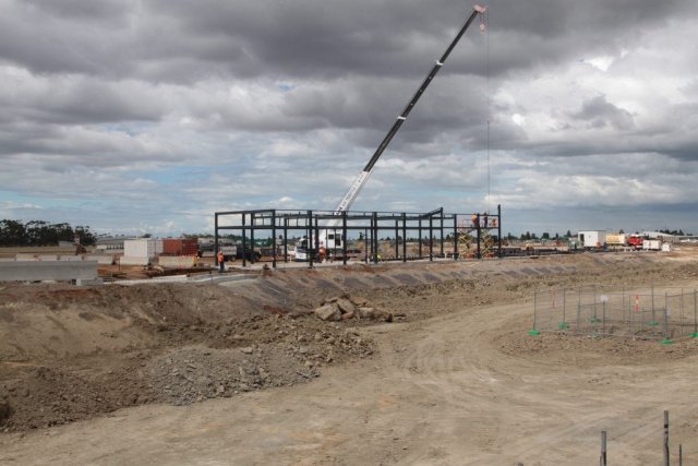 Crane erecting a steel framed building at Wyndham Vale station