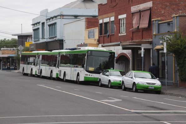 Collection of Dyson Group buses and changeover cars outside Essendon station for rail replacement work