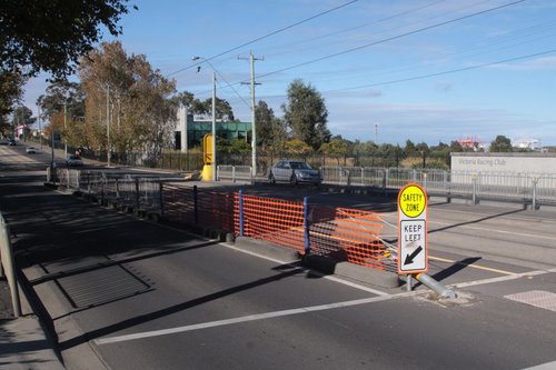 Red plastic safety fence and a new safety zone sign mark the site of the crash