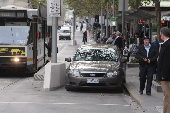 Car drives through the bike only part of the Swanston Street tram stop