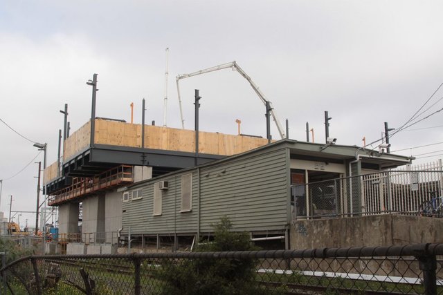 New overhead concourse looms over the decrepit timber structure