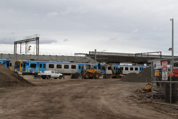 Down Werribee train passes beneath the new RRL viaduct outside Footscray