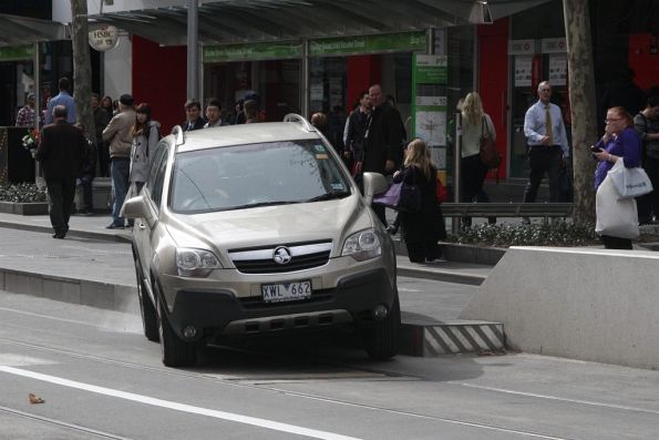 Motorist realises they can't get any further down the Swanston Street bike lane at the Bourke Street stop