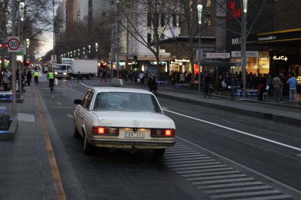 Confused old man drives down the Swanston Street bike lane at the Bourke Street stop