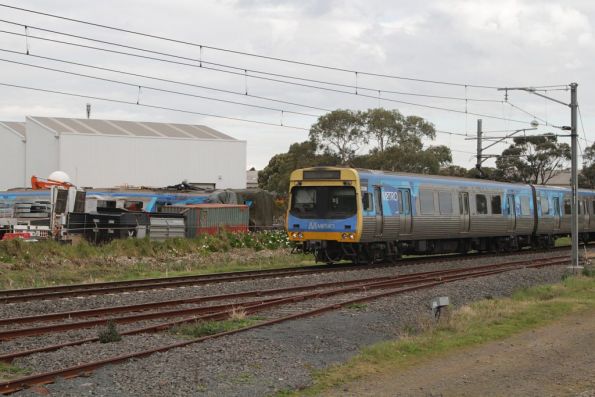 Comeng 352M on an up Cranbourne service passes three damaged classmates outside Dandenong