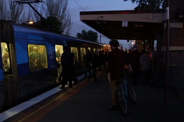 Passengers step onto a dark platform at Newmarket station