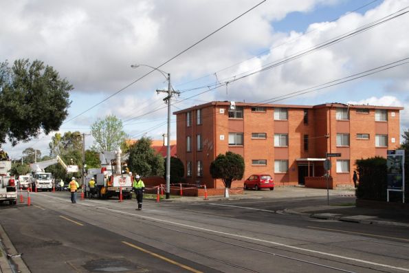 Work continues to restore mains power, the apartment block minus roof in the background